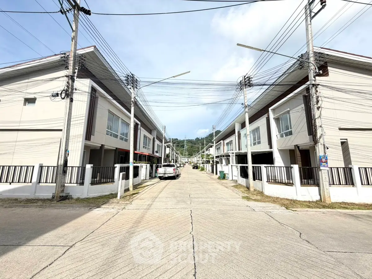 Modern townhouse complex with spacious driveways and mountain views, ideal for family living.