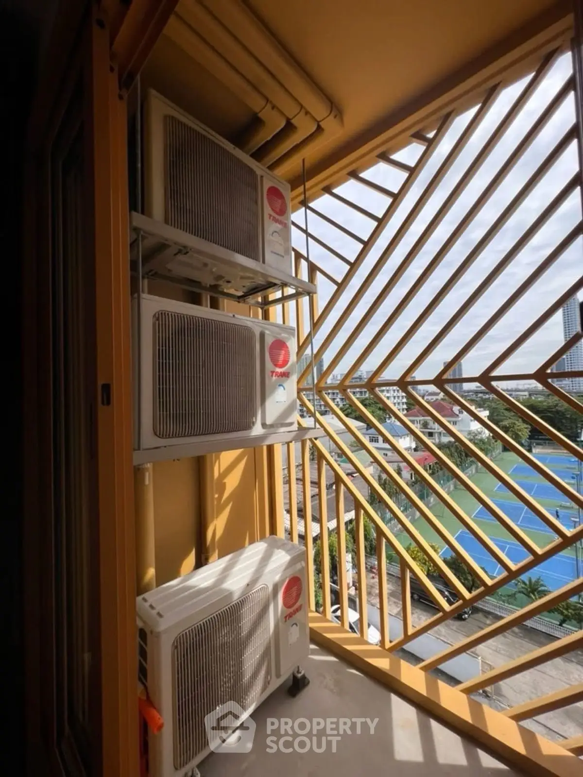 Modern balcony with air conditioning units and city view