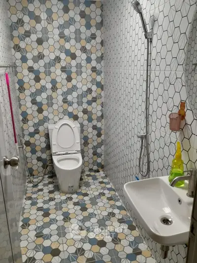 Stylish bathroom with geometric tile design and modern fixtures