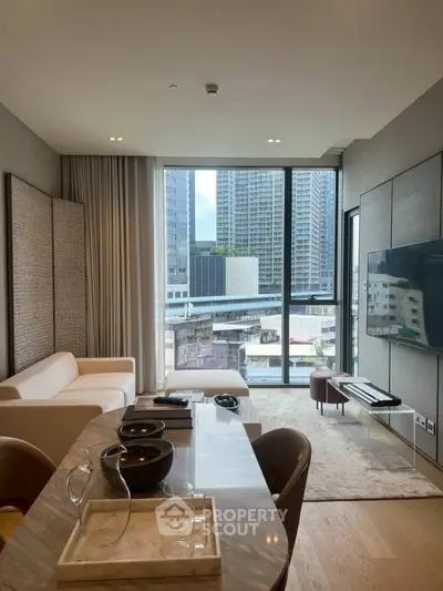 Modern living room with city view, stylish furniture, and large windows in urban apartment.