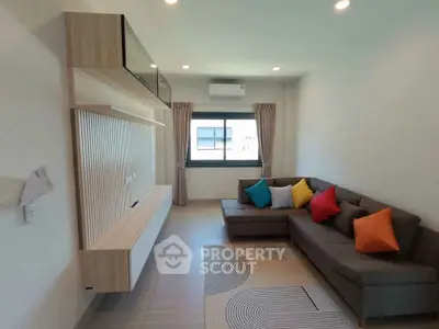 Modern living room with stylish sectional sofa and colorful cushions