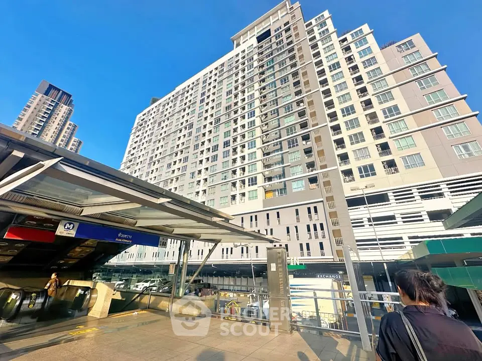 Modern high-rise building near public transportation in urban setting