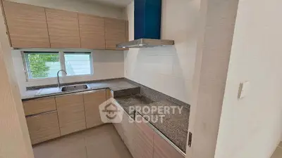 Modern kitchen with sleek cabinetry and granite countertops
