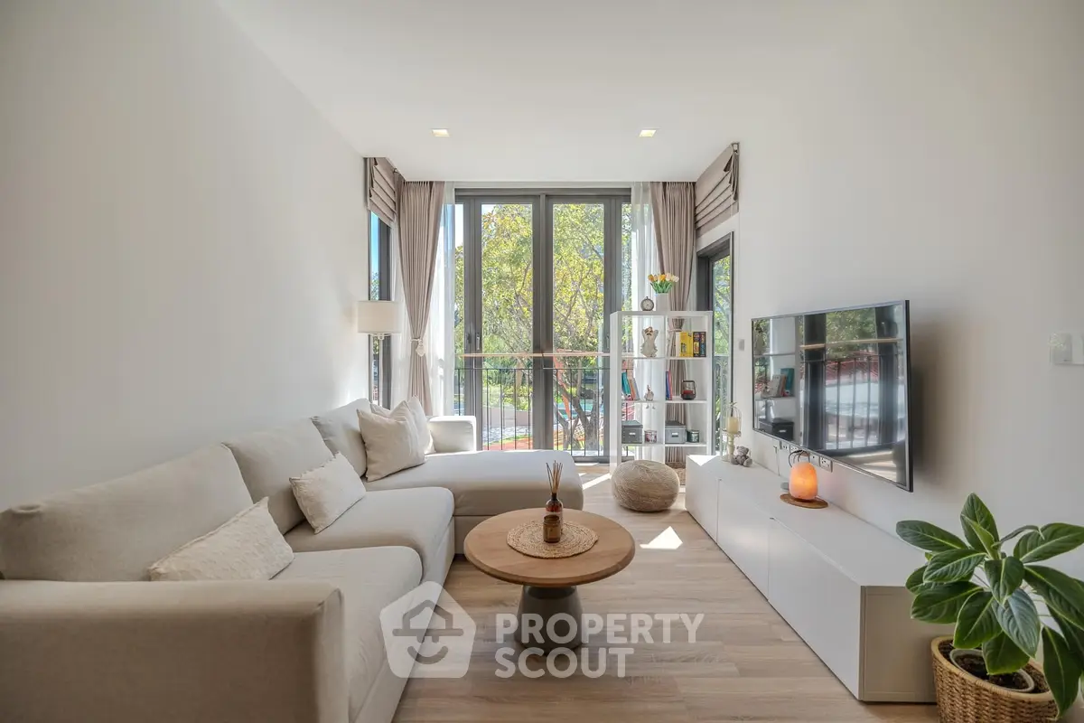 Spacious living room with modern decor and large windows offering a scenic view.