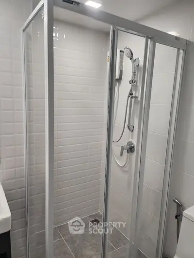 Modern bathroom with sleek shower enclosure and contemporary fixtures.