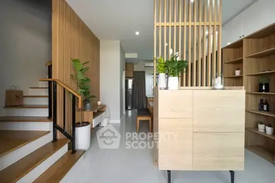 Modern open-plan living space with wooden accents and indoor plants