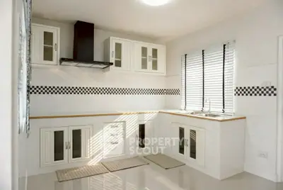 Modern kitchen with sleek cabinetry and checkered backsplash