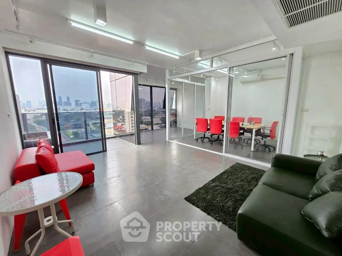 Spacious modern living room with city view and glass-walled office area