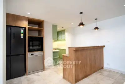 Modern kitchen with open layout, featuring sleek appliances and stylish lighting, perfect for culinary enthusiasts.