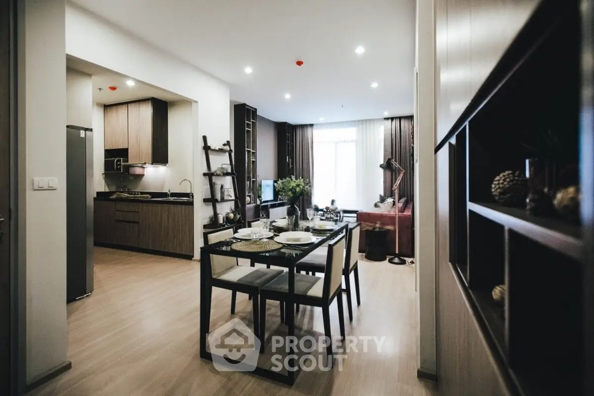 Modern open-plan living and dining area with stylish kitchen and cozy seating.