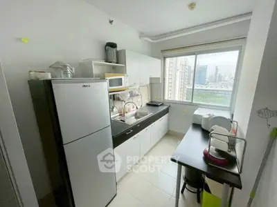 Modern kitchen with city view, featuring sleek appliances and ample counter space.
