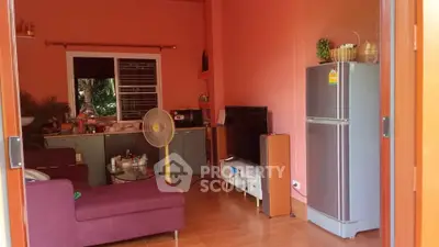 Cozy living room with vibrant decor and modern appliances, perfect for relaxation and entertainment.