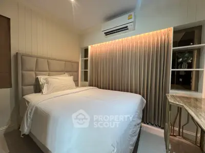 Cozy bedroom with elegant decor and air conditioning, perfect for restful nights.