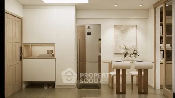 Modern kitchen with sleek design, featuring a stainless steel fridge and elegant dining area.