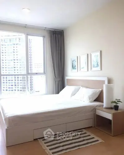 Bright and modern bedroom with large window and stylish decor in urban apartment.