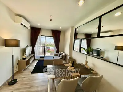 Modern living room with balcony view, stylish decor, and open layout
