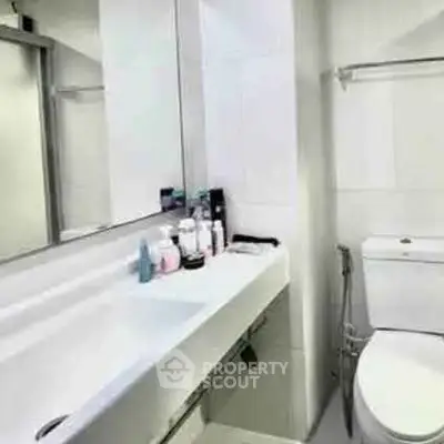 Modern bathroom with sleek fixtures and ample counter space.
