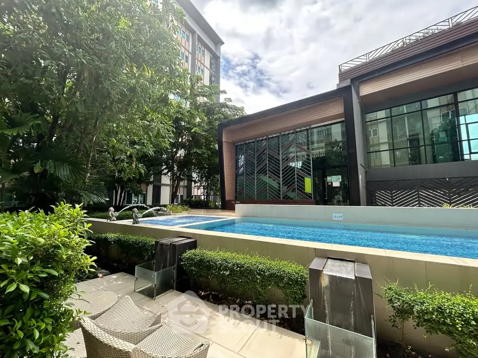 Luxurious residential pool area with modern architecture and lush greenery