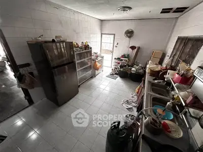 Spacious kitchen with stainless steel fridge and ample storage space.