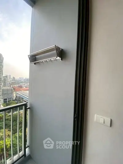 Modern balcony with city view and sleek wall-mounted drying rack.