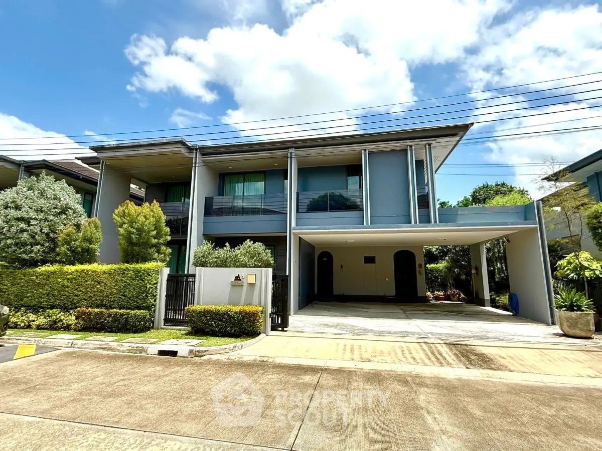 Modern two-story house with spacious driveway and lush greenery, perfect for family living.