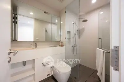 Modern bathroom with sleek design and glass shower enclosure.