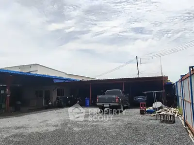 Spacious industrial property with ample parking and storage space, ideal for business operations.