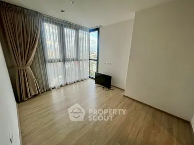 Spacious empty room with large windows and city view, perfect for customization.