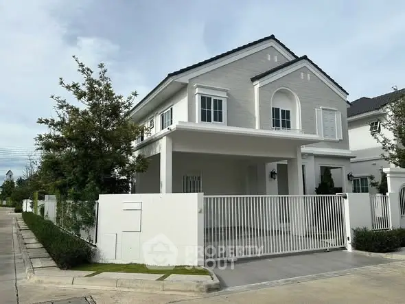 Elegant two-story house with modern design and spacious driveway in a serene neighborhood.