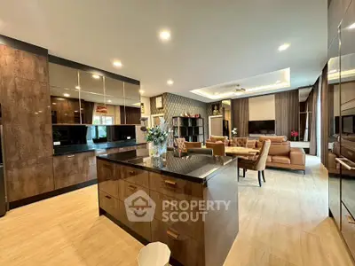 Luxurious open-plan living room with modern kitchen and elegant decor