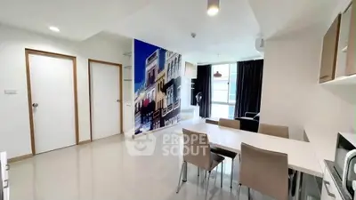 Modern dining area with sleek furniture and artistic wall mural in a bright apartment.