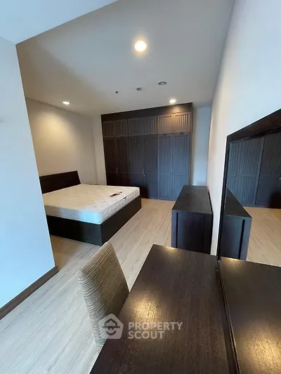 Spacious bedroom with modern furnishings and ample closet space