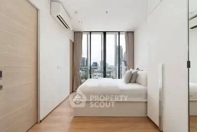 Modern bedroom with city view, featuring floor-to-ceiling windows and minimalist design.