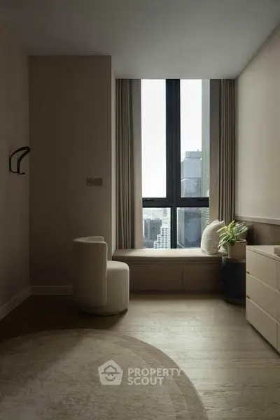 Elegant modern living room with city view, featuring cozy seating and stylish decor.