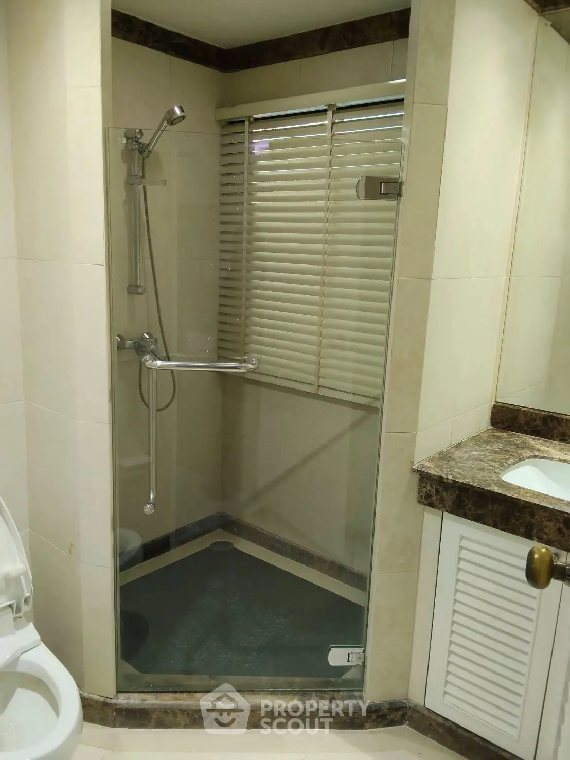 Modern bathroom with glass shower enclosure and sleek fixtures