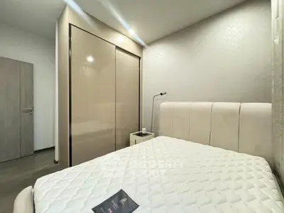 Modern bedroom with sleek wardrobe and comfortable bed in stylish apartment.