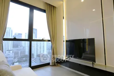 Modern living room with large windows offering stunning city views in a high-rise apartment.