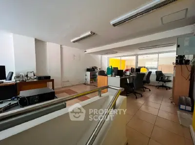 Spacious office space with modern furnishings and ample natural light