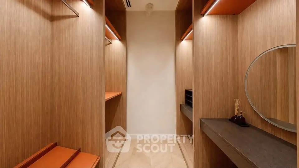 Luxurious walk-in closet with elegant wood finishes and modern design.