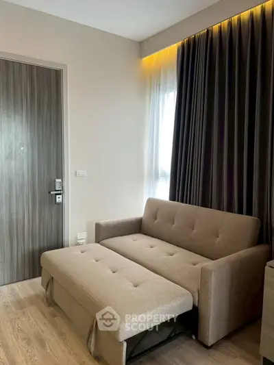 Modern living room with stylish sofa bed and elegant curtains, perfect for cozy urban living.
