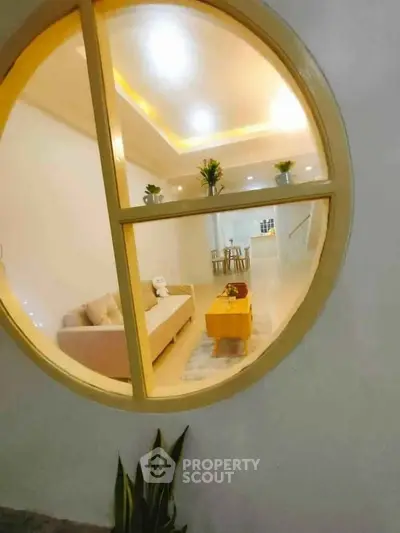 Modern living room with circular window and cozy seating area