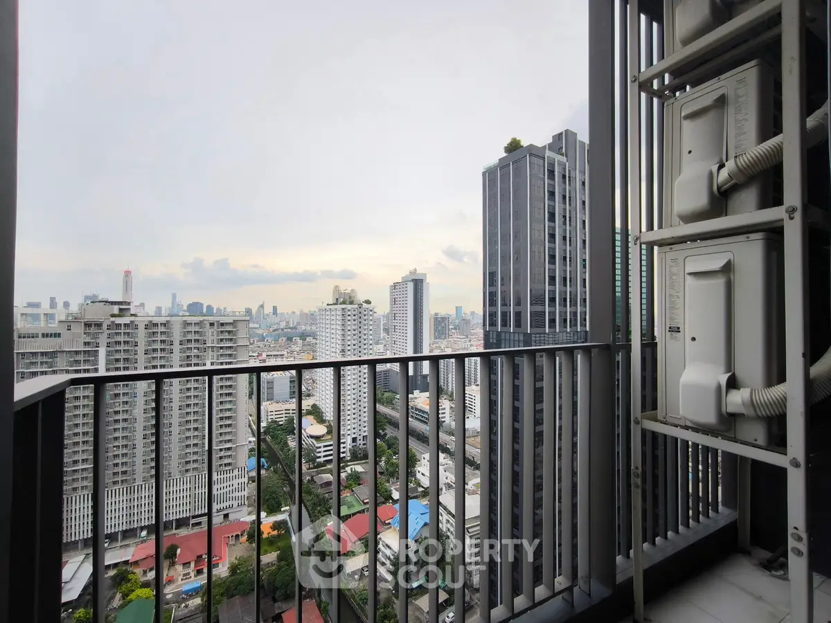 Stunning cityscape view from a high-rise balcony with modern architecture.