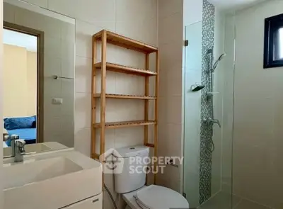 Modern bathroom with glass shower and wooden shelving unit