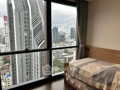Modern bedroom with stunning city view from floor-to-ceiling windows in high-rise apartment.