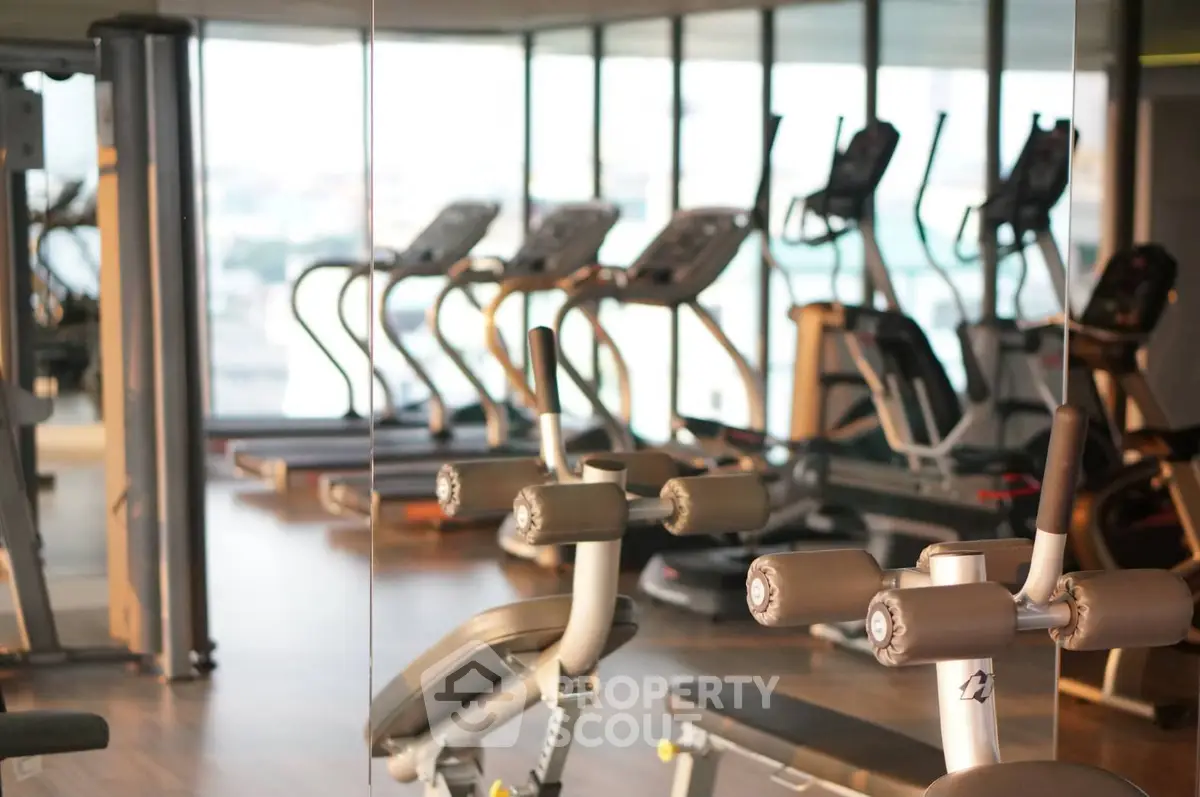 Modern gym with state-of-the-art fitness equipment and panoramic windows.