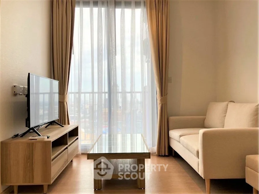 Bright and cozy living room with modern furniture and large window view.