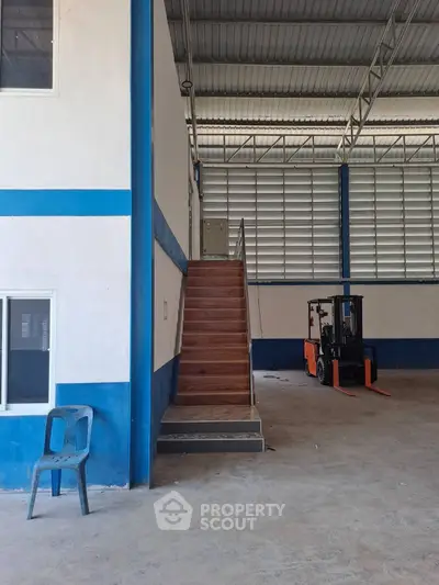Spacious industrial warehouse with high ceilings and forklift access