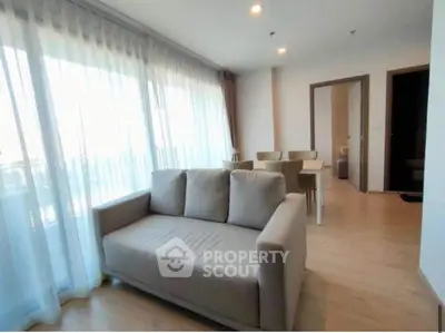 Spacious living room with modern furniture and large windows for natural light.