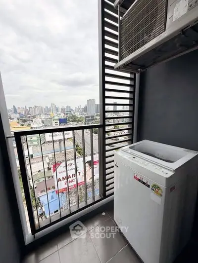 High-rise balcony with city view and washing machine, perfect for urban living.