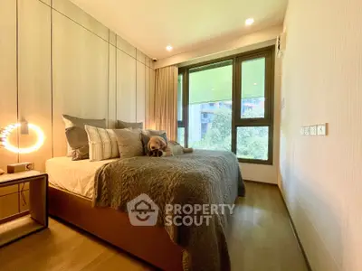 Luxurious bedroom with large window and modern decor, featuring a cozy bed and stylish lighting.